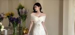Close-up of ivory off-shoulder dress lace-panel bodice and gathered neckline