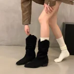 Black pointed-toe suede slouch mid-calf boots in angled view